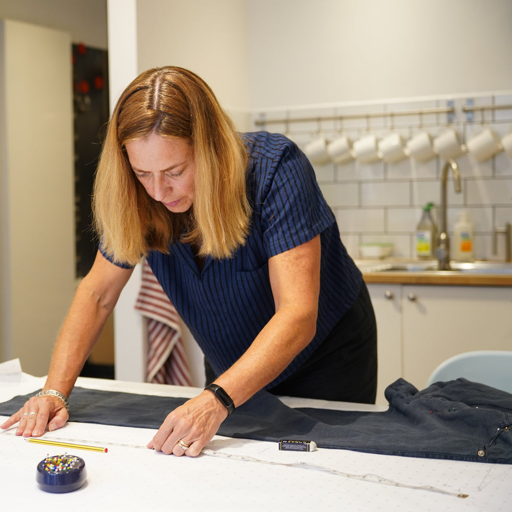 Woman working on a sewing project in a workshop setting