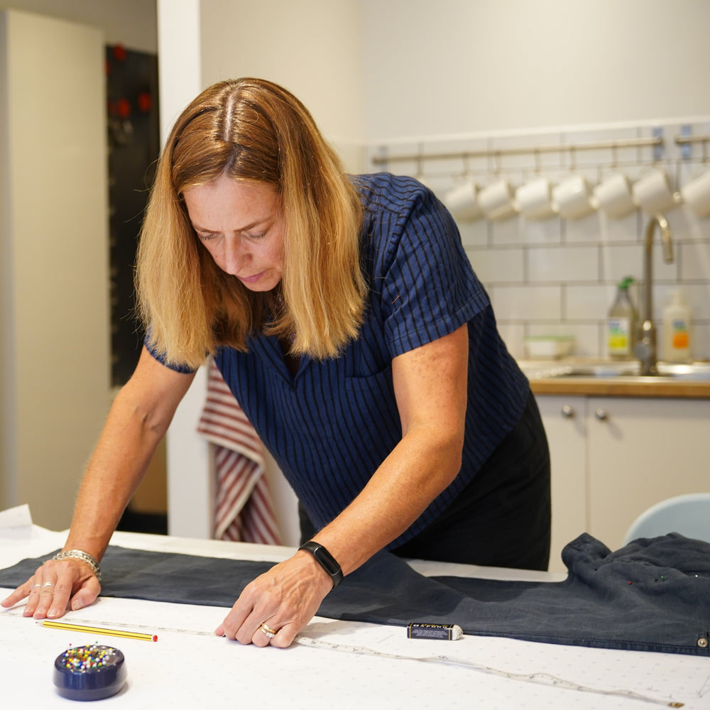 Woman working on a sewing project in a workshop setting