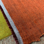 close up orange herringbone linen fabric