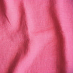 bright pink coloured and washed european linen fabric
