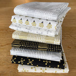 stack of gold and silver Christmas fabrics