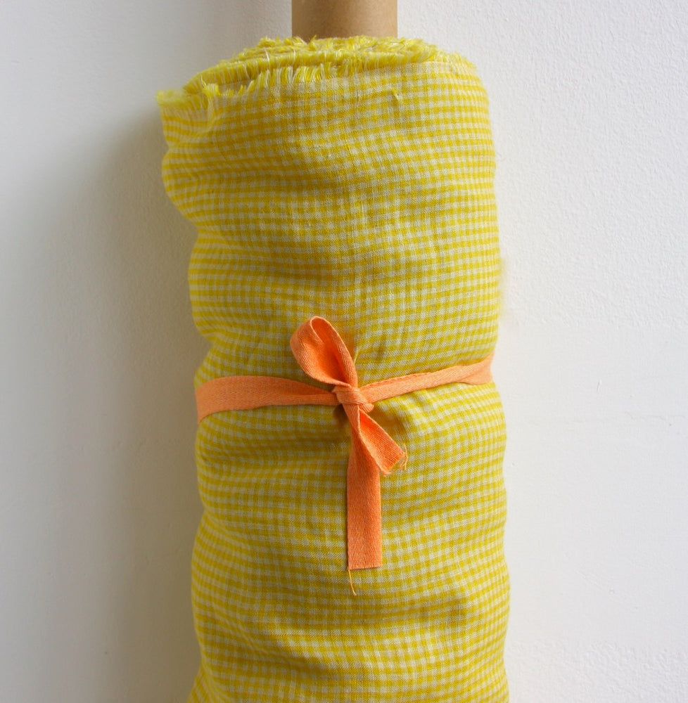 roll of yellow linen gingham fabric
