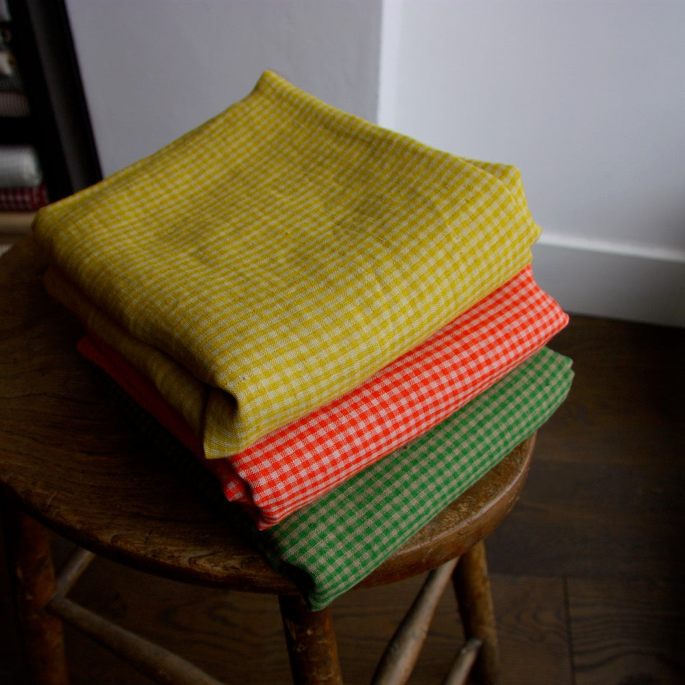 pile of folded yellow linen gingham fabric