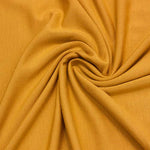eco friendly micro modal knit stretch jersey soft drapey fabric in golden yellow 