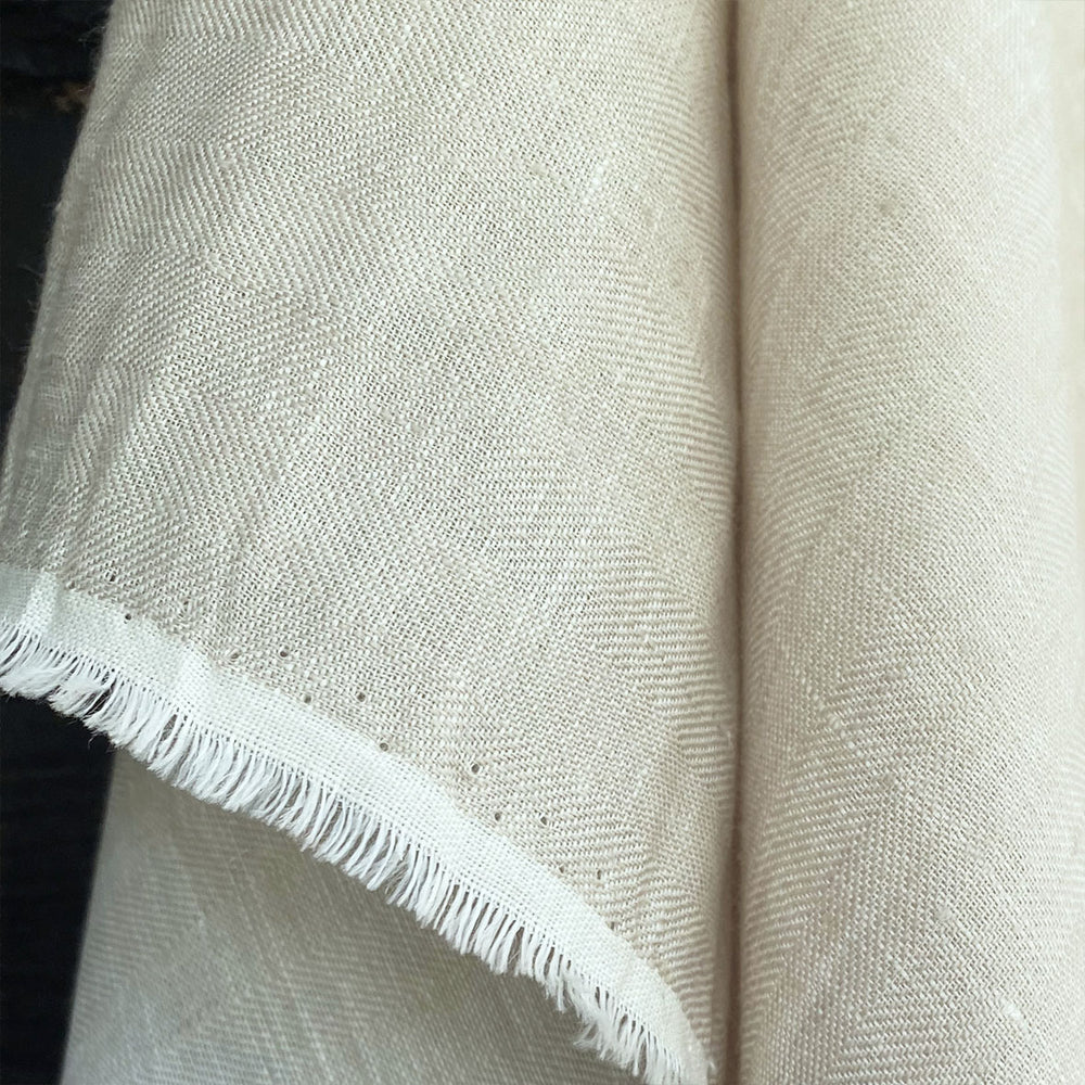 soft washed cream coloured linen herringbone weave fabric draping