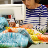 machine sewing a quilt