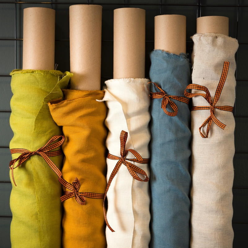 rolls of coloured and washed european linen fabric