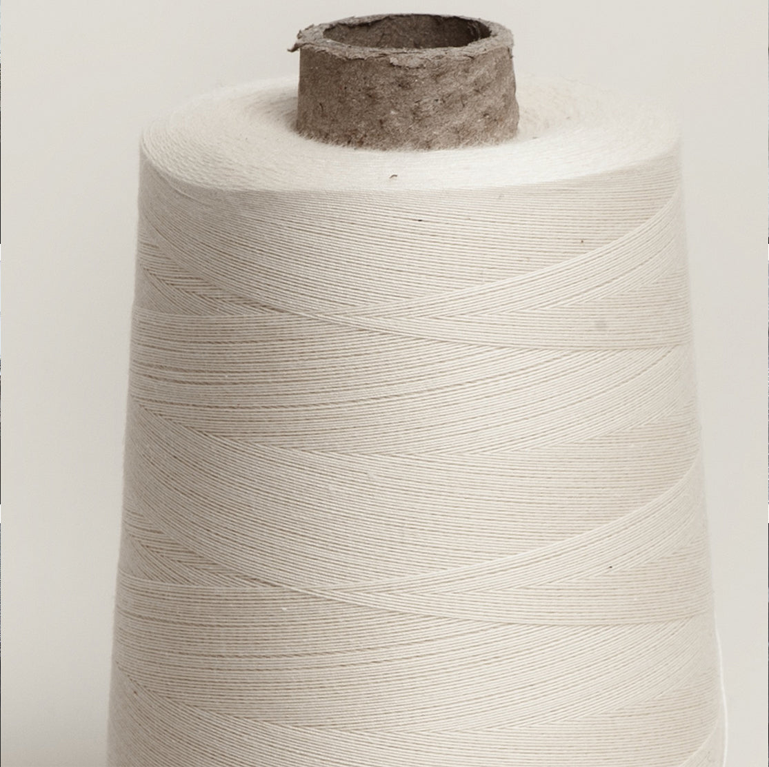 Unbleached Cotton Overlocker Spool on Cardboard Cone